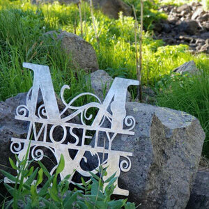 A photograph of a Shiny Steel / 18" x 18" / Indoor Split-letter Monogram (Special Offer) by the metal art manufacturer Kraken Design Co.